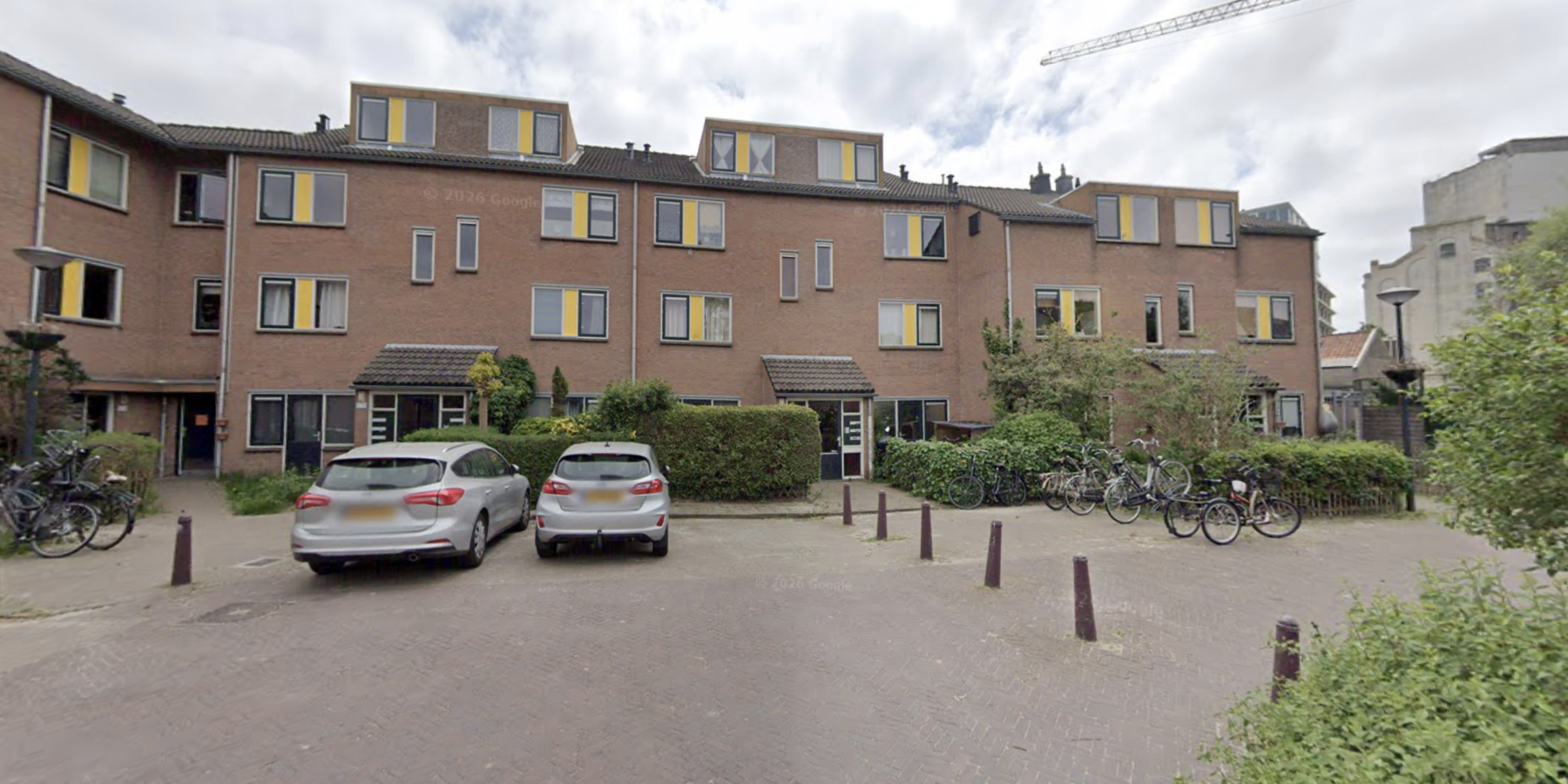 Parkeervakken met auto's in een woonwijk. De parkeervakken aan het Kwekerijplein in Leiden krijgen onderhoud.